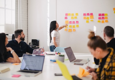 woman placing sticky notes on wall