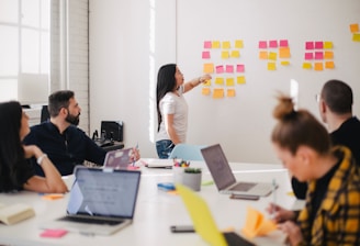 woman placing sticky notes on wall